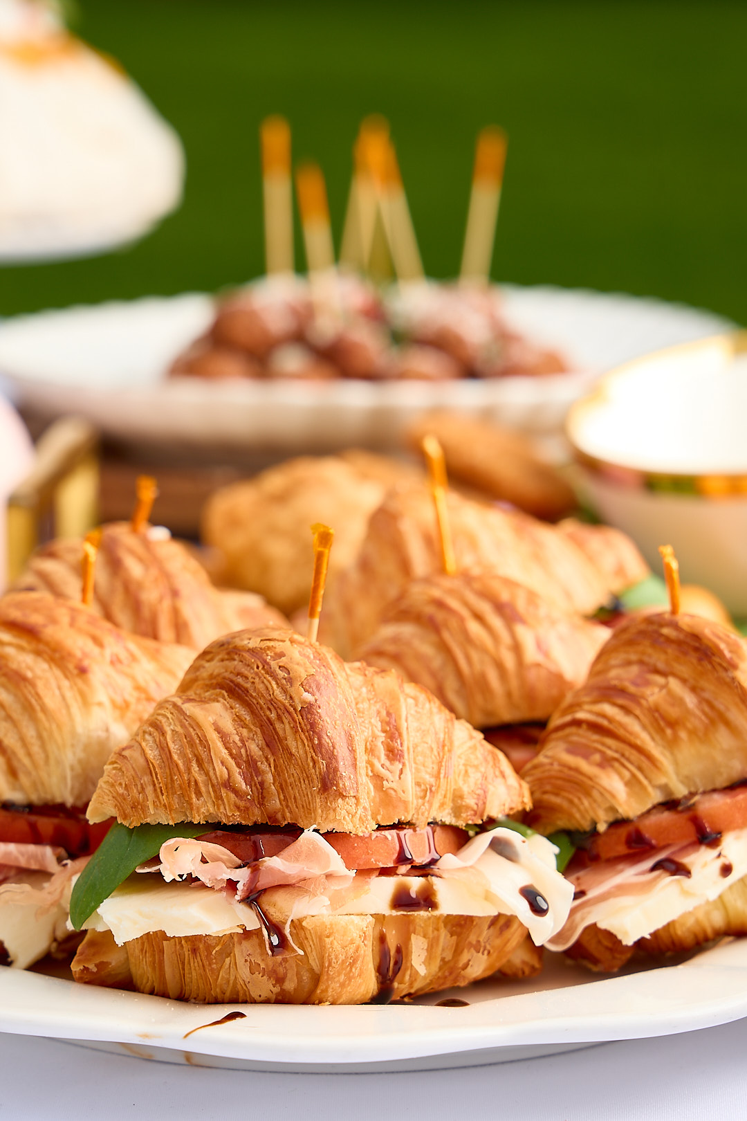 Mini croissants stuffed with prosciutto, brie, tomato, and balsamic.